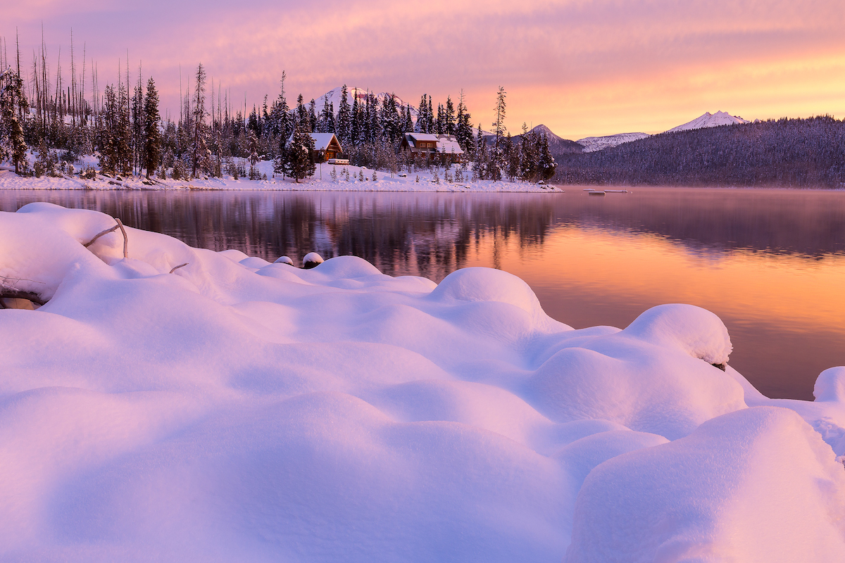 Elk Lake Cabin in the snow at sunset by Rich Bacon